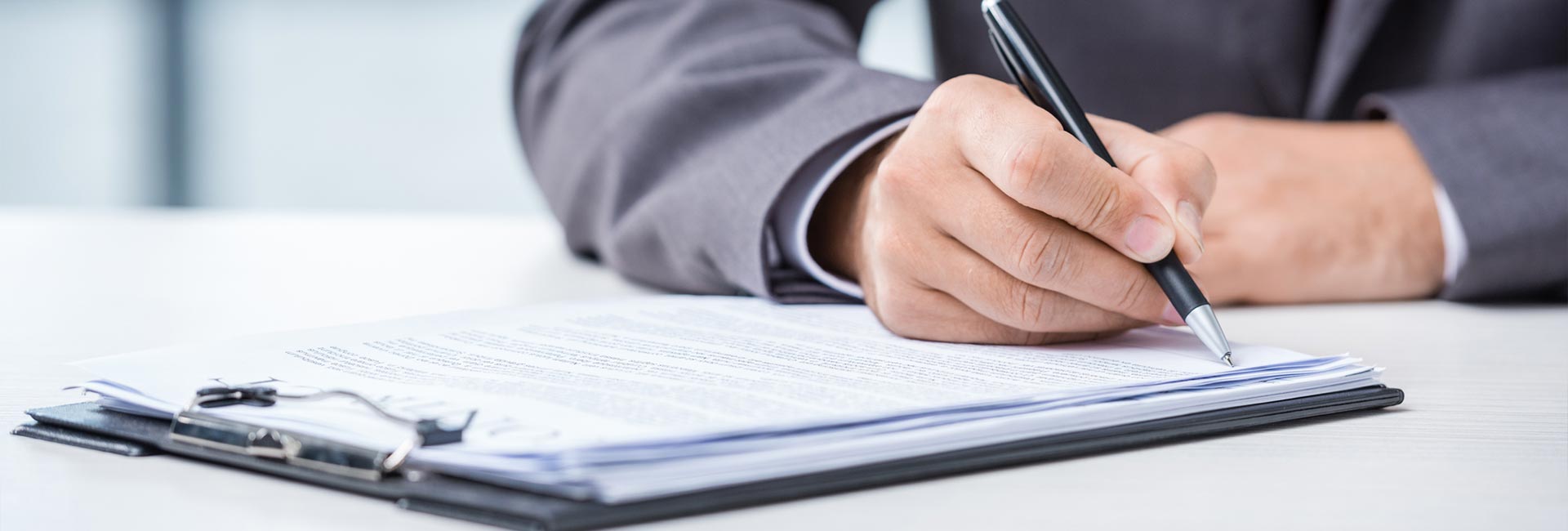 A business man signing a document